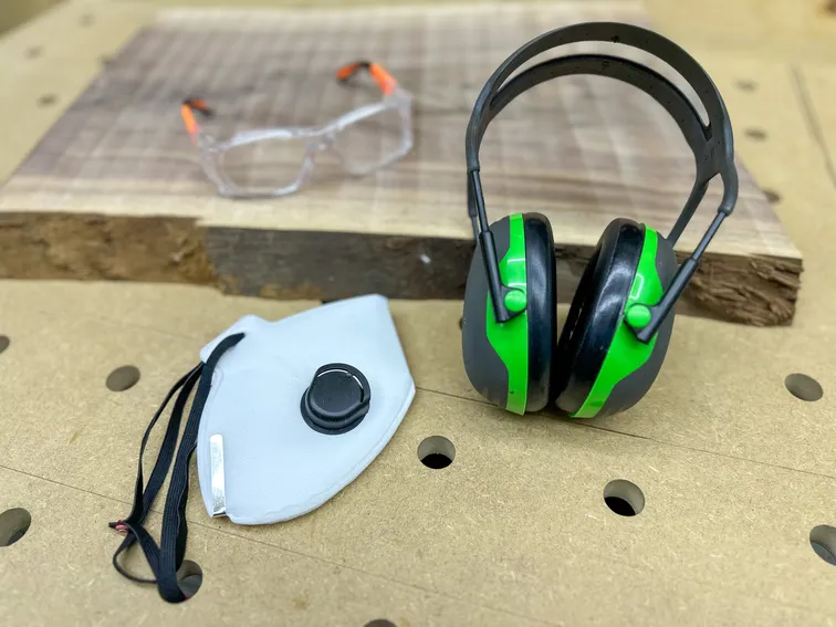 Workshop protective gear including safety glasses, hearing protection, and a respirator